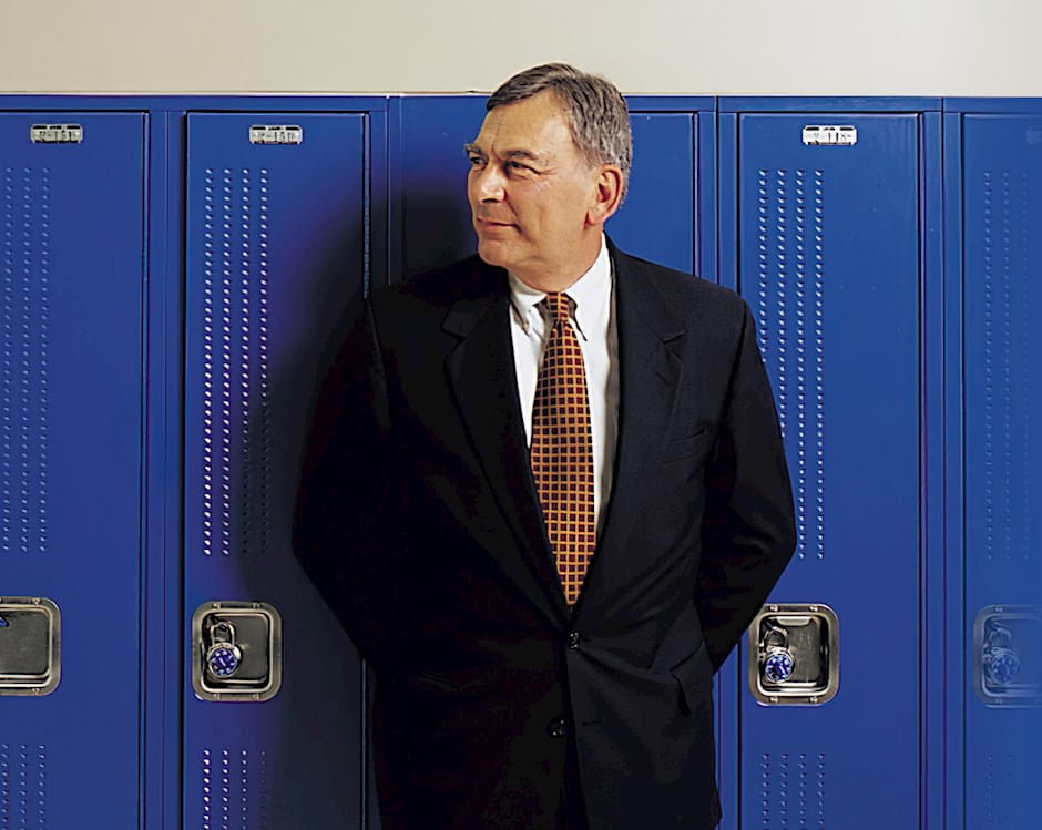 David J. Vitale wearing a suit standing in front of blue lockers