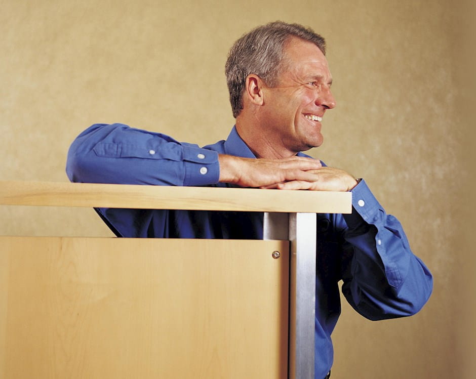 John A. Edwardson standing and smiling