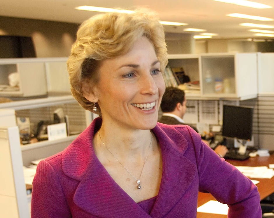 Kathryn Mikells conversing with a colleague